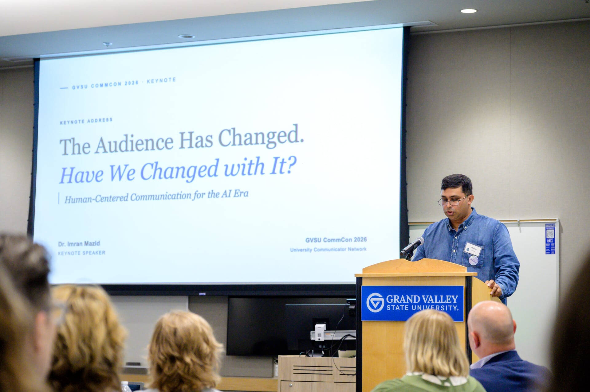 Imran Mazid at a podium, at his right is a screen with The Audience Has Changed. Have We Changed with It?